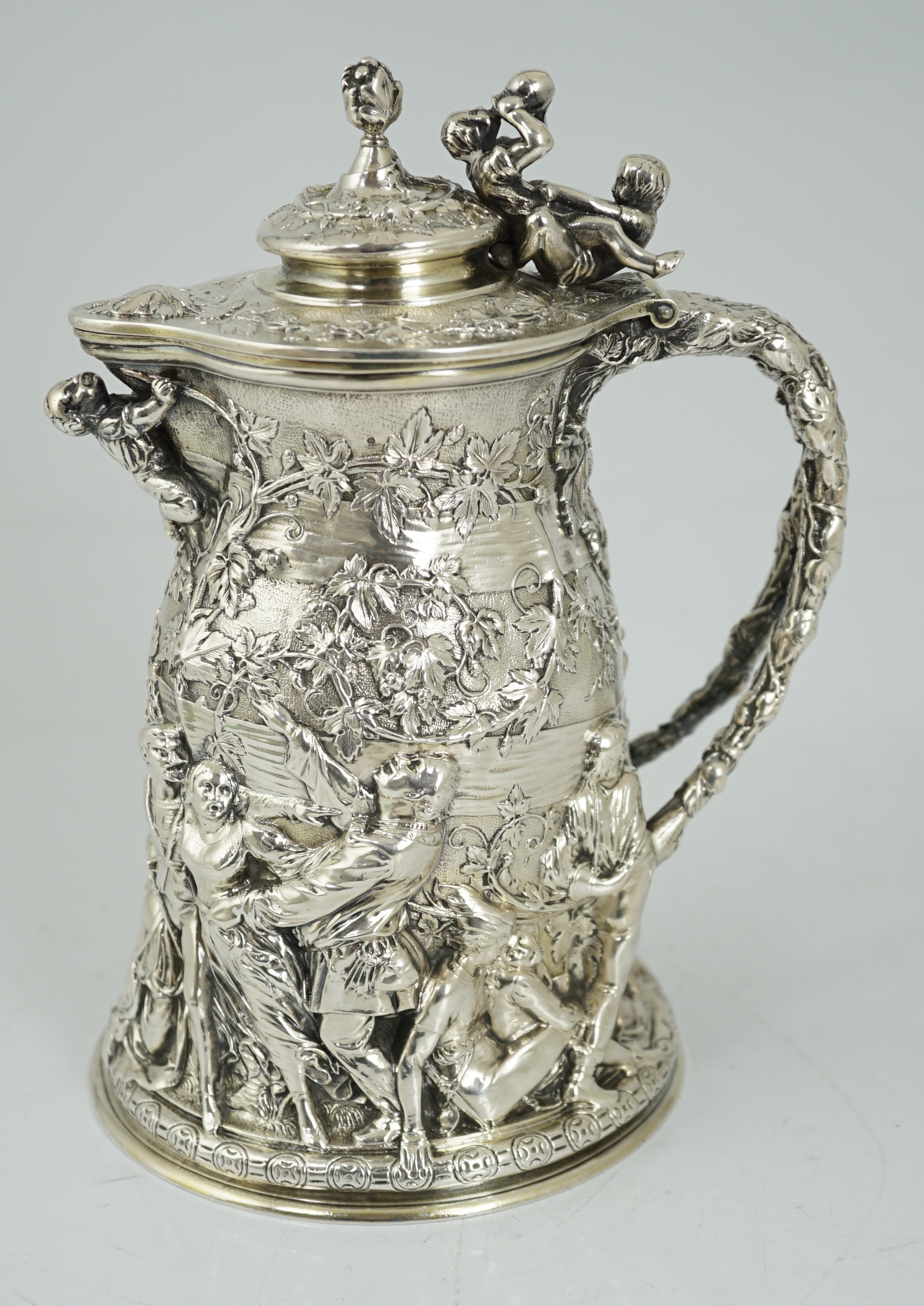 ROYAL INTEREST: A good ornate Victorian Teniers style silver ewer with hinged cover by Frederick Elkington